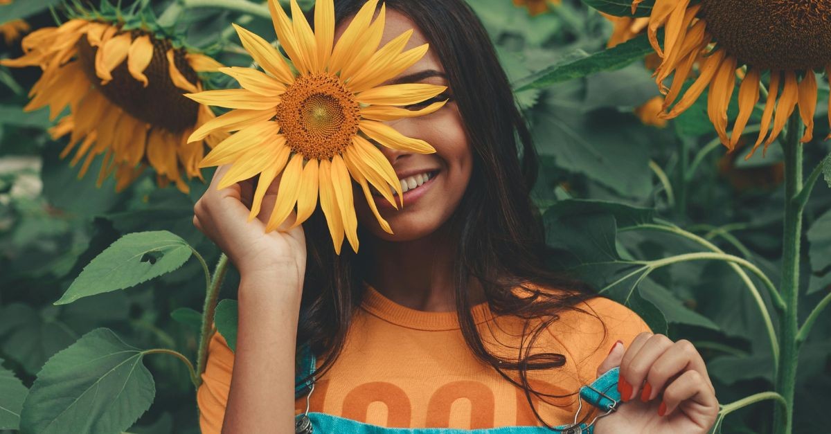Woman with a Sunflower in the Fall
